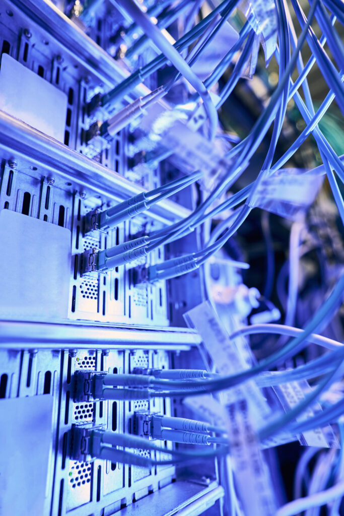 Close-up of network cables connected to servers in a modern data center representing scalable IT infrastructure and secure digital connectivity.