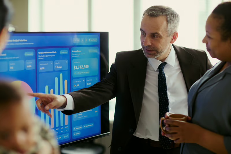 Enterprise IT leaders reviewing a business intelligence dashboard to align technology strategy with business outcomes